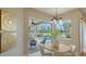 Bright dining area with modern light fixture and views of the screened-in pool area at 13625 3Rd Ne Ave, Bradenton, FL 34212