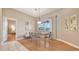 Bright dining room with pool view, a modern table setting, and an open layout to the kitchen at 13625 3Rd Ne Ave, Bradenton, FL 34212