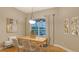 Elegant dining room with large window, stylish light fixture, and contemporary decor at 13625 3Rd Ne Ave, Bradenton, FL 34212