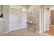 Inviting foyer features double doors, neutral color palette, decorative table and tile flooring at 13625 3Rd Ne Ave, Bradenton, FL 34212