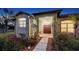 Inviting front entrance featuring a double door, elegant columns, and lush landscaping at 13625 3Rd Ne Ave, Bradenton, FL 34212