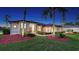 Beautifully landscaped home exterior featuring manicured lawn, mature palms, and inviting front facade at 13625 3Rd Ne Ave, Bradenton, FL 34212