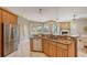 Well-appointed kitchen with stainless steel appliances, granite countertops, and a breakfast bar overlooking the living space at 13625 3Rd Ne Ave, Bradenton, FL 34212