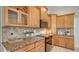 Well-lit kitchen featuring granite countertops, tiled backsplash, and light wood cabinetry at 13625 3Rd Ne Ave, Bradenton, FL 34212