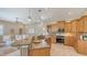 Open-concept kitchen featuring a breakfast bar, stainless steel appliances, and views to the living area at 13625 3Rd Ne Ave, Bradenton, FL 34212
