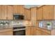 Kitchen featuring granite countertops, tiled backsplash, and stainless steel microwave and oven at 13625 3Rd Ne Ave, Bradenton, FL 34212