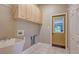 Functional laundry room with sink, storage cabinets, and convenient exterior door at 13625 3Rd Ne Ave, Bradenton, FL 34212
