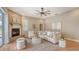 Living room featuring a fireplace, neutral decor, and wood-style flooring at 13625 3Rd Ne Ave, Bradenton, FL 34212