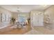 Bright living room with elegant decor, large windows, and a seamless flow into the entryway at 13625 3Rd Ne Ave, Bradenton, FL 34212