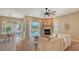 Cozy living area with fireplace and sliding glass doors that lead to a screened-in pool at 13625 3Rd Ne Ave, Bradenton, FL 34212