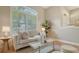 Comfortable living room with a stylish couch, decorative pillows, and abundant natural light at 13625 3Rd Ne Ave, Bradenton, FL 34212
