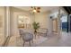 Inviting covered patio with seating, fan and neutral tones provides a comfortable outdoor living space at 13625 3Rd Ne Ave, Bradenton, FL 34212