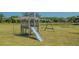Outdoor wooden playset in a large backyard, perfect for Gathering fun and outdoor play at 13625 3Rd Ne Ave, Bradenton, FL 34212