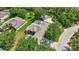 Aerial view of the house with screened-in pool, garage, and surrounding trees at 14104 E 22Nd Ter, Bradenton, FL 34212