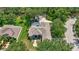 Beautiful aerial view of a home with a screened-in pool and lush green landscaping at 14104 E 22Nd Ter, Bradenton, FL 34212