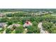 An aerial view of a single-Gathering home surrounded by lush trees and a well-manicured lawn in a peaceful neighborhood at 14104 E 22Nd Ter, Bradenton, FL 34212