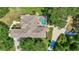 Aerial view of a house with screened pool, landscaped backyard and connecting driveway to a garage at 14104 E 22Nd Ter, Bradenton, FL 34212