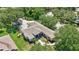 An aerial view of the beautiful home, featuring a large screened pool and lush landscaping at 14104 E 22Nd Ter, Bradenton, FL 34212