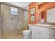 Updated bathroom features a glass-enclosed shower, granite countertop, and modern fixtures at 14104 E 22Nd Ter, Bradenton, FL 34212