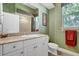 Bathroom with vanity, framed mirror, decorative wallpaper, and shower at 14104 E 22Nd Ter, Bradenton, FL 34212
