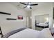 Cozy bedroom with closet, featuring a modern ceiling fan, and a sleek wall-mounted TV at 14104 E 22Nd Ter, Bradenton, FL 34212
