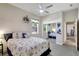 Bedroom featuring ample natural light, ceiling fan, and mirrored closet at 14104 E 22Nd Ter, Bradenton, FL 34212