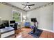 Comfortable bedroom featuring hardwood floors, ceiling fan, and a tranquil view from the bright window at 14104 E 22Nd Ter, Bradenton, FL 34212
