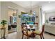 Inviting dining area featuring a glass table set with views of the screened-in pool and outdoor living space at 14104 E 22Nd Ter, Bradenton, FL 34212