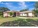 Spacious home showcasing manicured lawn, tasteful landscaping, and a stone-accented facade at 14104 E 22Nd Ter, Bradenton, FL 34212