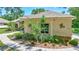 Charming single-story home featuring lush landscaping, unique details, and a welcoming walkway at 14104 E 22Nd Ter, Bradenton, FL 34212