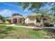 Charming single-story home with lush landscaping, brick accents, and a curved walkway leading to the entrance at 14104 E 22Nd Ter, Bradenton, FL 34212