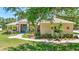 Charming single-story home featuring lush landscaping, blue door, stone details, and a welcoming walkway at 14104 E 22Nd Ter, Bradenton, FL 34212