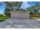 A two-car garage with a concrete driveway, and an American flag at 14104 E 22Nd Ter, Bradenton, FL 34212