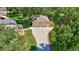 Aerial view of a two-car garage, extra parking and landscaping on a sunny day at 14104 E 22Nd Ter, Bradenton, FL 34212