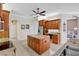 Spacious kitchen with an island, wooden cabinets, and modern stainless-steel appliances at 14104 E 22Nd Ter, Bradenton, FL 34212