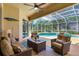 Relaxing screened-in lanai with comfortable seating overlooking a beautiful swimming pool and lush landscaping at 14104 E 22Nd Ter, Bradenton, FL 34212