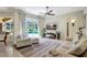 Relaxing living area with comfortable seating, a modern ceiling fan, and a view of the screened-in pool at 14104 E 22Nd Ter, Bradenton, FL 34212