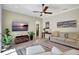 Spacious living room with a modern ceiling fan, contemporary decor, and ample natural light at 14104 E 22Nd Ter, Bradenton, FL 34212