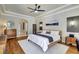 Spacious main bedroom featuring tray ceiling, hardwood floors, walk in closet, and neutral decor at 14104 E 22Nd Ter, Bradenton, FL 34212