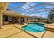 The backyard pool area features a screened enclosure, ample seating, and lush landscaping at 14104 E 22Nd Ter, Bradenton, FL 34212