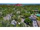 An aerial view showing the community nestled among trees, with a pool visible in the distance at 1532 Pelican Point Dr # 240, Sarasota, FL 34231