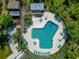 Aerial view of a unique resort style community pool, with mature landscaping and plenty of room to relax at 1532 Pelican Point Dr # 240, Sarasota, FL 34231