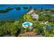 Beautiful aerial view of a community with a pool near the ocean and lush greenery at 1532 Pelican Point Dr # 240, Sarasota, FL 34231