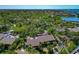 Aerial view of the property nestled among trees, showcasing screened lanais and the community landscape at 1532 Pelican Point Dr # 240, Sarasota, FL 34231