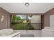 Cozy balcony with wicker furniture showcasing landscaped community views at 1532 Pelican Point Dr # 240, Sarasota, FL 34231
