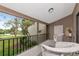 Balcony featuring wicker chairs with an open view of pool and community landscape at 1532 Pelican Point Dr # 240, Sarasota, FL 34231