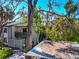 Charming condo building with lush landscaping, mature trees, and dedicated parking spots at 1532 Pelican Point Dr # 240, Sarasota, FL 34231