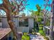 Charming condo building with lush landscaping, mature trees, and dedicated parking spots at 1532 Pelican Point Dr # 240, Sarasota, FL 34231