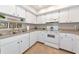 Bright kitchen featuring white cabinetry, stainless steel sink, and modern appliances at 1532 Pelican Point Dr # 240, Sarasota, FL 34231