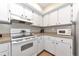 Bright kitchen featuring white cabinetry and modern appliances at 1532 Pelican Point Dr # 240, Sarasota, FL 34231
